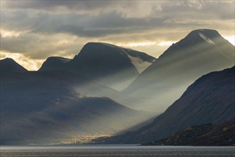 Clouds and sunbeams above fjord