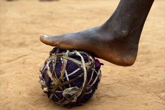 Child playing football with homemade ball