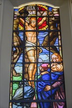 Colourful window with Christ on the cross