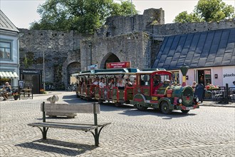 Tourist train in front of the city wall