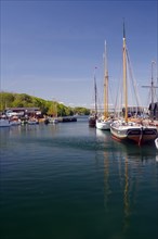 Sailing ships in a small harbour