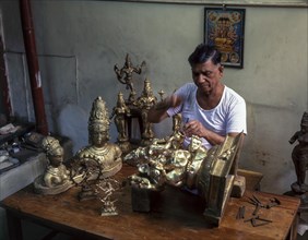 Artisan making bronze sculptures