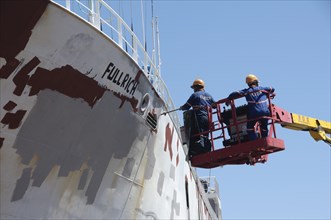 Cargo ship being repainted in dry dock