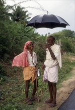 Two village man talking about Agriculture during a rainy season Tamil Nadu