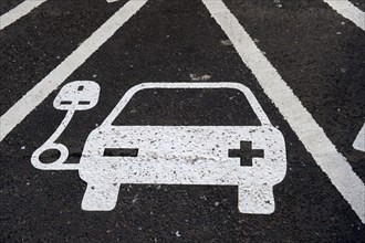 Reserved parking space at electric car charging point at motorway service station