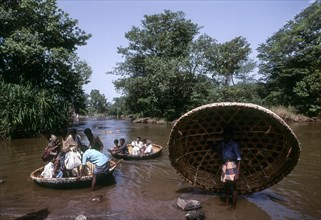 Tourists enjoying coracle ride in River Cauvery