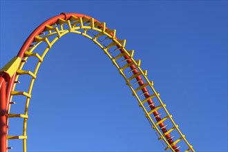 Roller coaster in front of blue sky