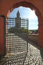 Witch's tower with archway and metal gate from the Residenzschloss in the backlight in Idstein