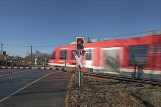 Passing train at a level crossing with barriers