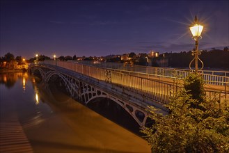 Bridge over the river during the flood at dusk