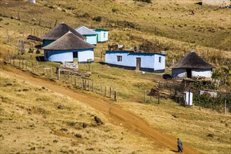 Hilly landscape characterised by the colourful huts
