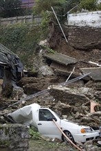 Landslide with van buried under debris in a coastal town