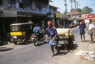 Coolie Pulling the hand cart at Kozhikode
