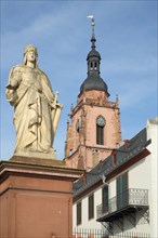 Germania figure on the square of Montrichard with tower of St. Peter and Paul Church in Eltville
