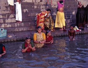 Pilgrims worshipping Ganga River in Varanasi