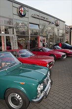 Alfa Romeo classic car in front of Alfa Romeo branch