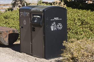 Solar-powered waste disposal containers and compactors