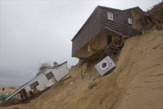 Eroded sea cliffs and damaged chalets after the December 2013 tsunami