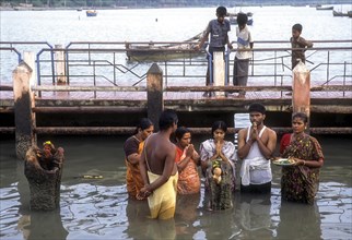 A group of people worshipping Navagraha idols