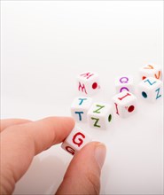 Colorful alphabet letter cubes in handon a white background