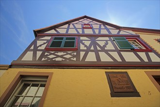 View upwards to the gable of a half-timbered house with shutters in Oestrich