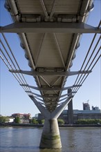 Under the steel suspension bridge over the river