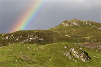 View of rainbow over mountains