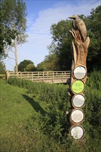 Wooden sculpture and information signpost
