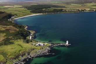 Aerial view of coastline and lighthouse