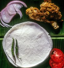 Pathiri with chicken in banana leaf. Pathiri is a traditional food of Kerala muslims. It is a pancake made of rice flour