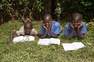 Smiling Rwandan children reading school books. Rwanda