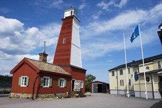 Wooden lighthouse in fishing village