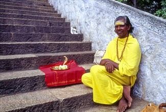 A Sadhu sitting on the steps of Arulmigu Dhandayuthapani Swamy Temple at Palani near Coimbatore