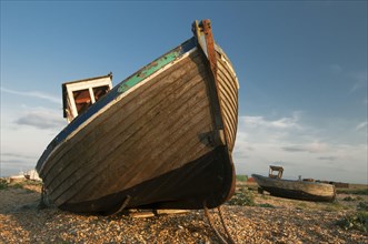 Abandoned fishing boats on shingle beach