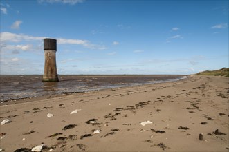 View of beach and former lighthouse converted to water-tower