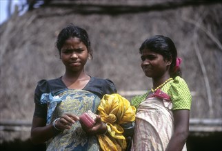 Betta Kurumba tribal Ladies standing in front of the hut