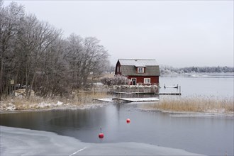 View of house and frozen lake
