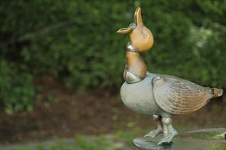 Bronze duck with open beak from the duck fountain at the Duck Square in Eltville