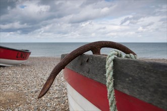 Close-up of anchor in fishing boat on shingle beach