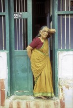 A bramin old lady standing in front of her Agraharam house at Sundarapandiapuram near Courtallam