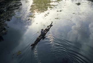 Fisherman in a small wooden boat