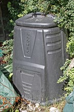Plastic compost bin in garden