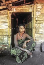 Mudunga tribal woman sitting in front of the hut a tribal village near Silent Valley
