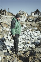 Serhiy Melnyk stands on the ruins of his house in the residential district of Bohunia