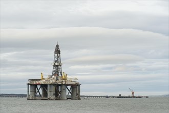 Oil rig moored in sea near coast