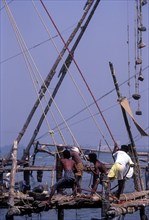 Operating the Chinese fishing nets in Fort Kochi