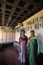 Kodava Women standing in her traditional home in Kodagu