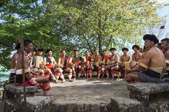 Naga tribesmen in front of a traditional house