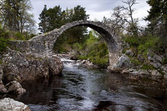 18th century stone packhorse bridge over the river