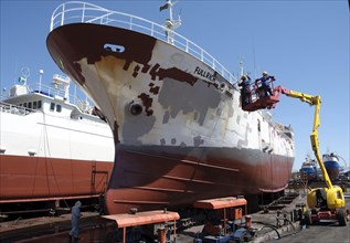 Cargo ship being repainted in dry dock